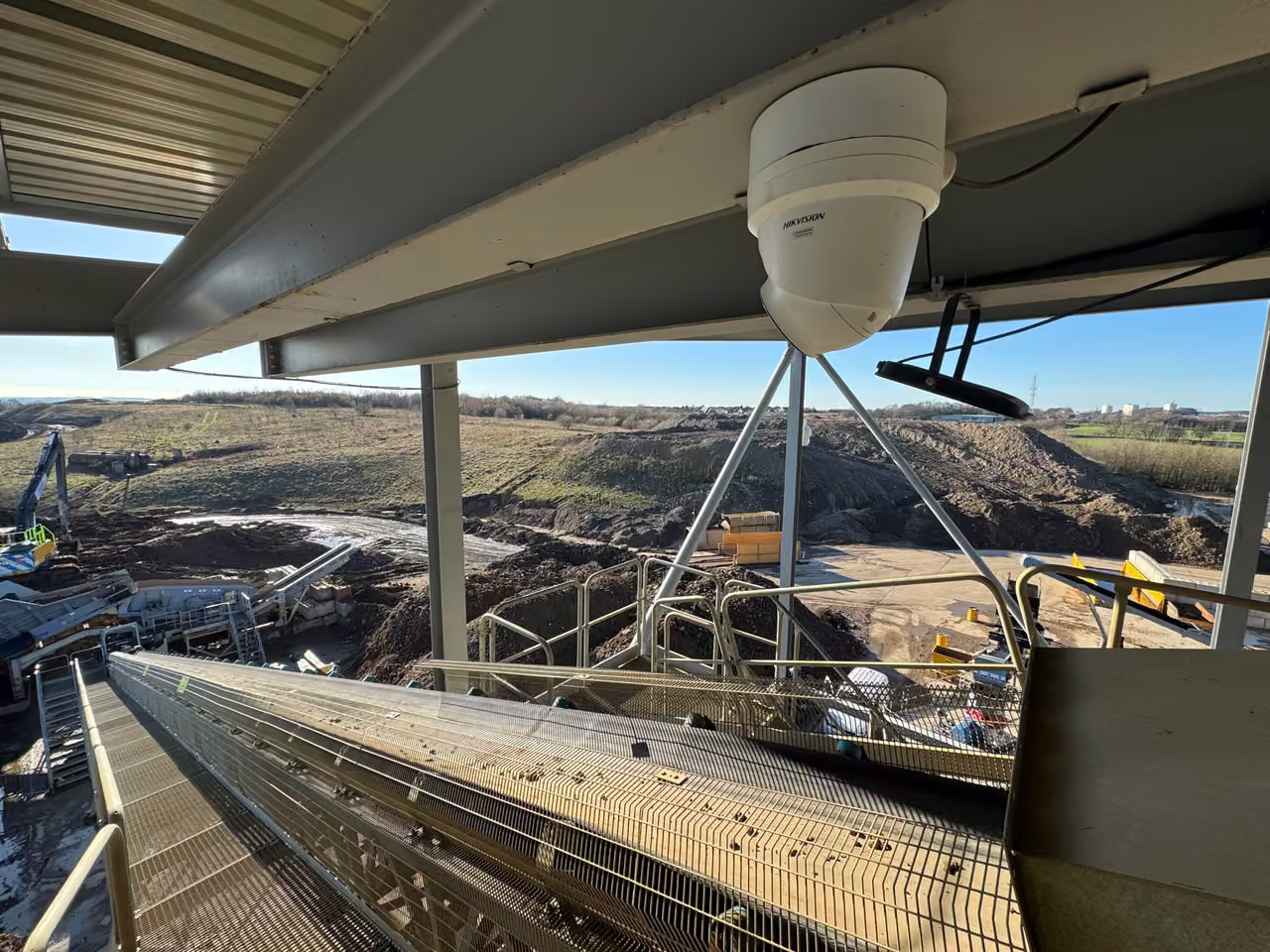 CCTV and process equipment overlooking an industrial recycling yard