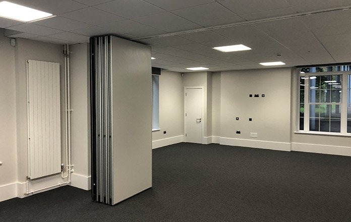 Completed office space with vertical radiator and pipework